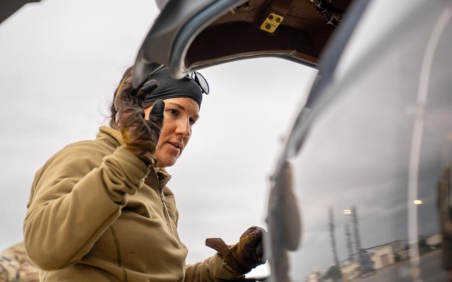 Tech. Sgt. Shelby "Scar" Duncan, a 33rd Rescue Squadron special missions aviator, performs pre-flight checks on an HH-60W Jolly Green II before its first flight at Kadena Air Base, Okinawa, Feb. 27, 2024.