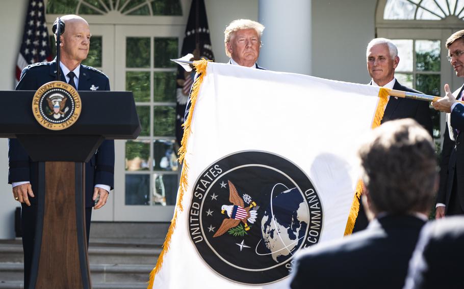 President Donald Trump looks on as a flag to establish the U.S. Space Command is unveiled in August 2019. 