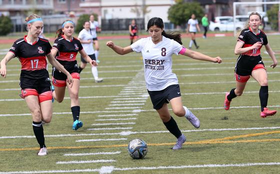 Perry's Leilani Zuniga dribbles upfield with three E.J. King defenders in her wake. At left is the Cobfas' Kinsey Bottorff (17). Zuniga scored two goals, giving her 12 on the season.