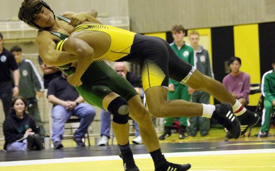 Kubasaki's Hayden Potter sends Kadena's Kai Christy airborne at 158 pounds during Wednesday's Okinawa wrestling dual meet. Potter won by technical fall 15-4 and the Dragons won the meet 39-26.