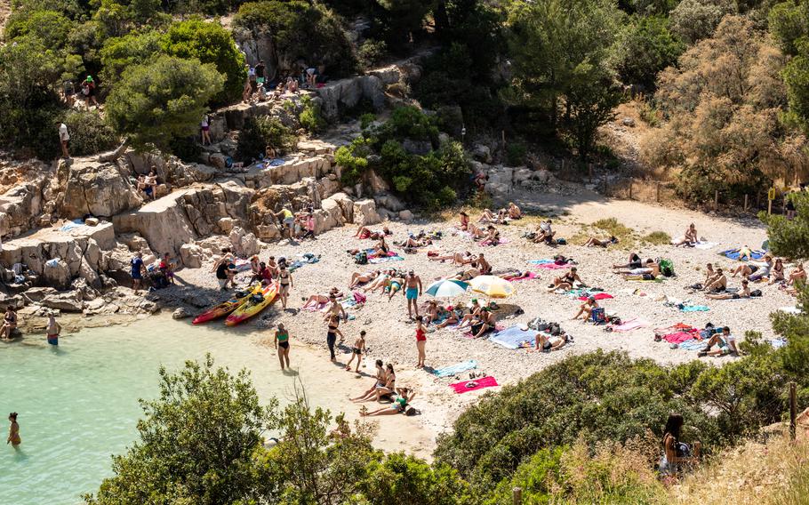People rest on a beach in the National Park of Calanques, France, on June 12. 