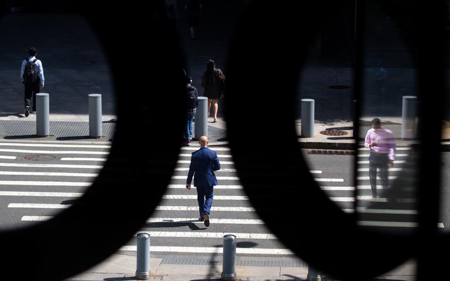 Workers arrive at Goldman Sachs headquarters in New York on June 15, 2022.