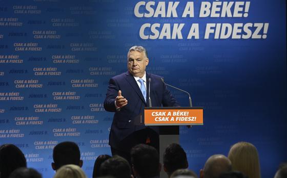 Hungarian Prime Minister and Chairman of Fidesz party Viktor Orban addresses a rally launching the campaign of the party for the European Parliamentary and the local elections in Budapest, Hungary, Friday, April 19, 2024. The inscription reads The peace only! The Fidesz only! Hungarian Prime Minister Viktor Orbán on Friday painted a grim picture of a continent teetering on the edge of armed conflict in a speech opening his party's campaign for European Union elections. He called for a changing of the guard among the bloc's leaders. (Szilard Koszticsak/MTI via AP)