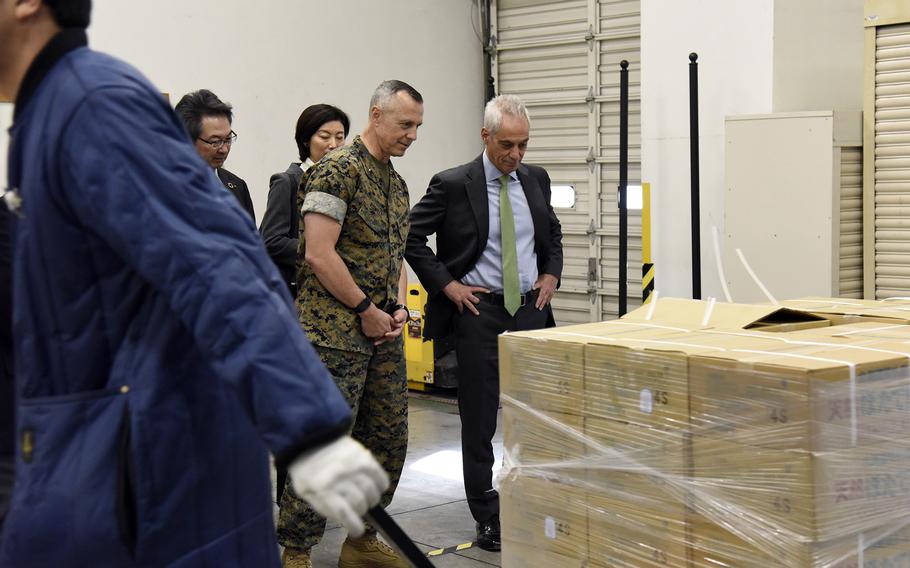 U.S. Ambassador to Japan Rahm Emanuel and Marine Corps Brig. Gen. George Rowell, deputy commander of U.S. Forces Japan, watch as Hokkaido scallops are delivered to the commissary at Yokota Air Base, Japan, Tuesday, Oct. 31, 2023.
