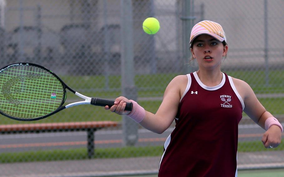 Matthew C. Perry’s Ren Foslin hits a forehand return during Friday’s tennis matches against Zama. Foslin won her girls doubles and mixed doubles matches.