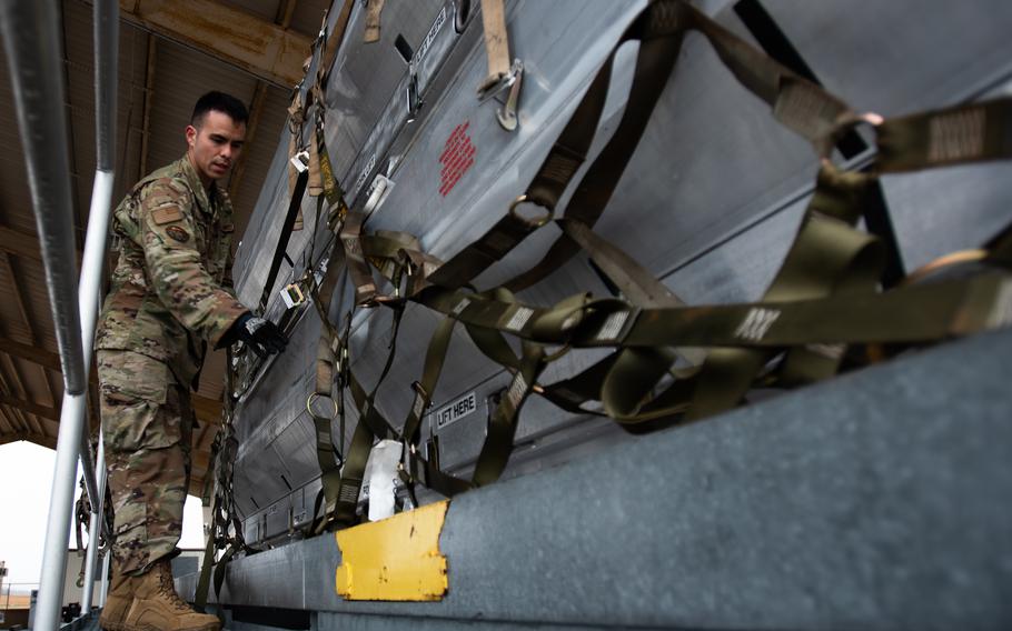 Air Force Staff Sgt. Rafael DeGuzman-Paniagua, a 305th Aerial Port Squadron special handling representative, secures a pallet of equipment at Joint Base McGuire-Dix-Lakehurst, N.J., on March 24, 2022. The 305th Air Mobility Wing is sending equipment to Europe as part of U.S. security assistance to Ukraine. 
