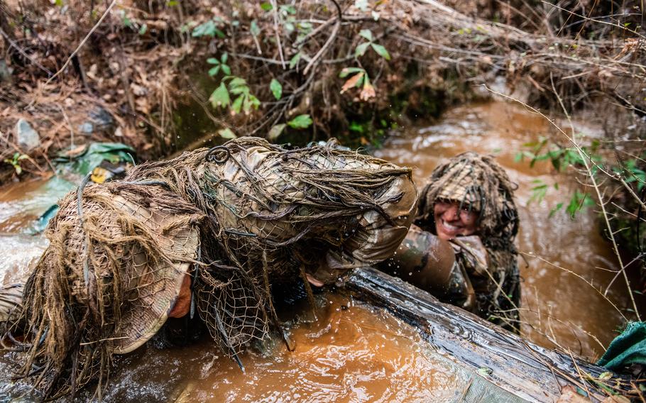 Sniper School students participate in the ghillie wash, which is designed to test the strength and durability of the suits as well as weather them. The Army is now considering whether hemp could add to the ghillie suit’s camouflage properties. 
