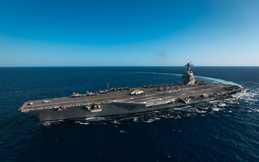 An aircraft carrier is seen at sea.