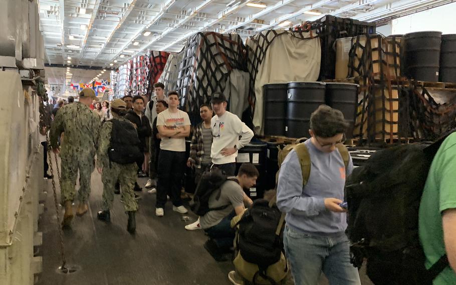 Sailors on the USS Harry S. Truman wait in line for a ferry to take them ashore to Naples, Italy, on May 11, 2022. The carrier arrived in Naples the day before for a port visit. 