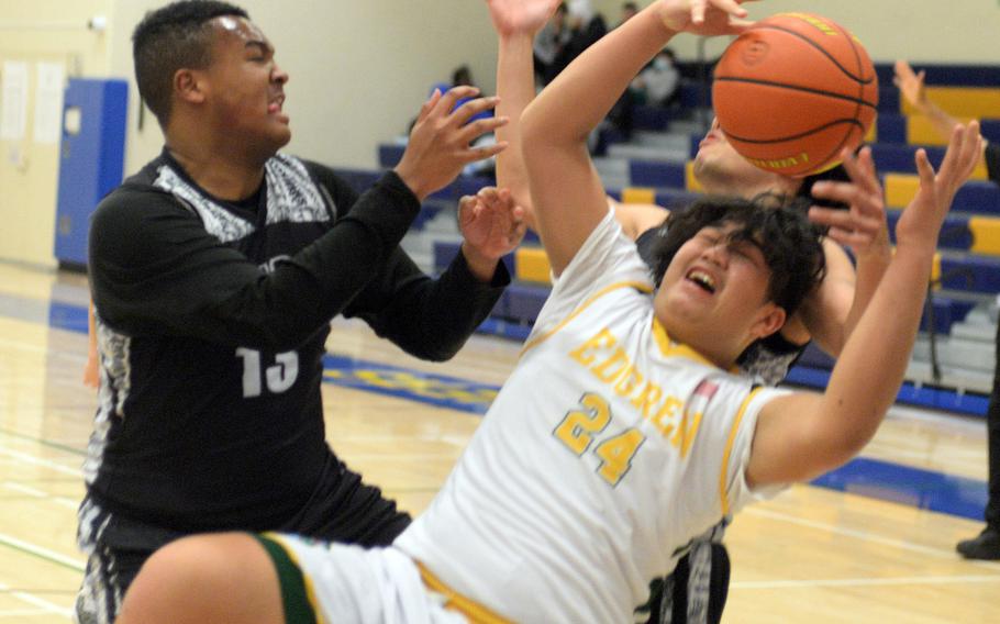 Zama's Tim Armstrong and Robert D. Edgren's Jayse Ulechong battle for a loose ball during Monday's Far East Boys Division II tournament pool-play game, won by the Trojans 71-51.