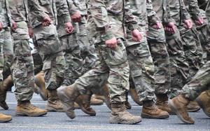A photo of Soldiers in uniform marching.