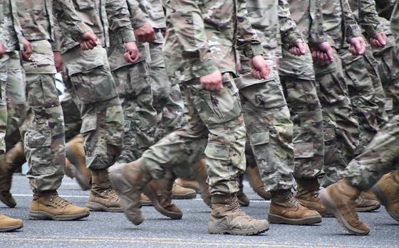 A photo of Soldiers in uniform marching.