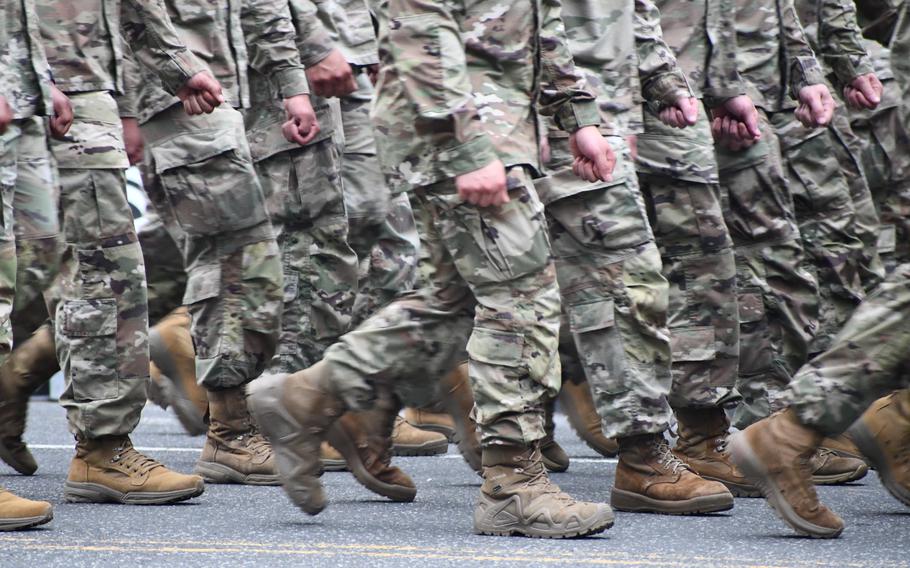 A photo of Soldiers in uniform marching.