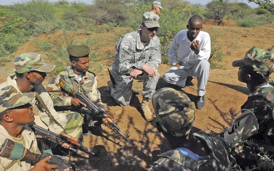 Sgt. First Class Bill Flippo, 27, of Winfield, Kan., speaks through an interpreter while teaching basic infantry tactics to Ethiopian soldiers in the field at Hurso.  