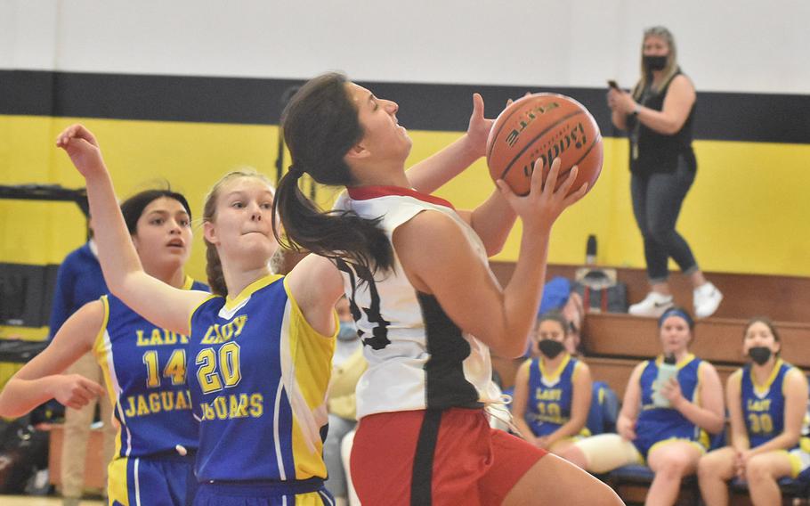 American Overseas School of Rome's Alexis Lambert tries to get up a shot past Sigonella's Emese Hrizcu during the championship game of the DODEA-Europe Division II girls tournament on Saturday, March 5, 2022.