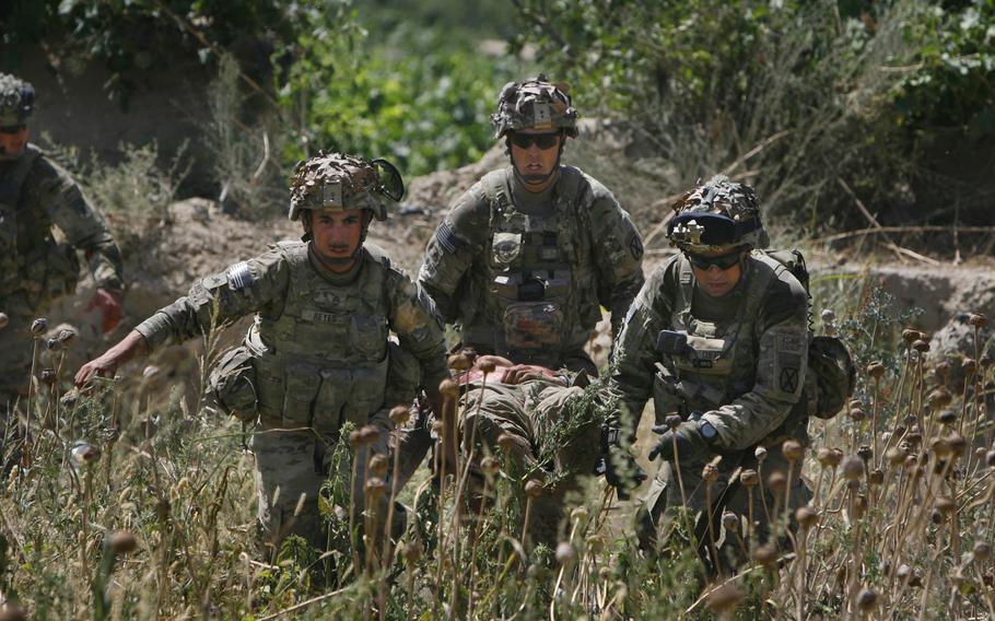 Sgt, Thomas Reyes, left, Staff Sgt. Mike Waxler, and Staff Sgt. Darren Cufaude, all of 2nd Battalion, 87th Infantry Regiment, 3rd Brigade Combat Team, 10th Mountain Division, evacuate one of several soldiers who were wounded during an improvised explosive device attack on June 18, 2011 near Pashmul North in Kandahar province, Afghanistan. 