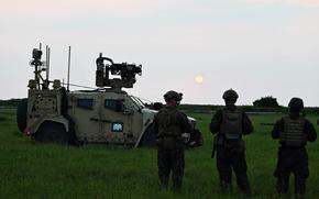 Members of the 3rd Marine Littoral Regiment watch the sun set near the South China Sea during a Balikatan drill.