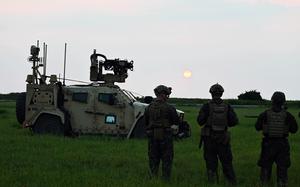 Members of the 3rd Marine Littoral Regiment watch the sun set near the South China Sea during a Balikatan drill.