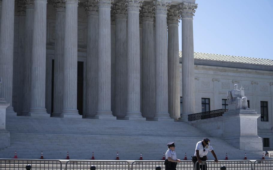 U.S. Supreme Court police officers stand outside in Washington, D.C., on June 17, 2021.