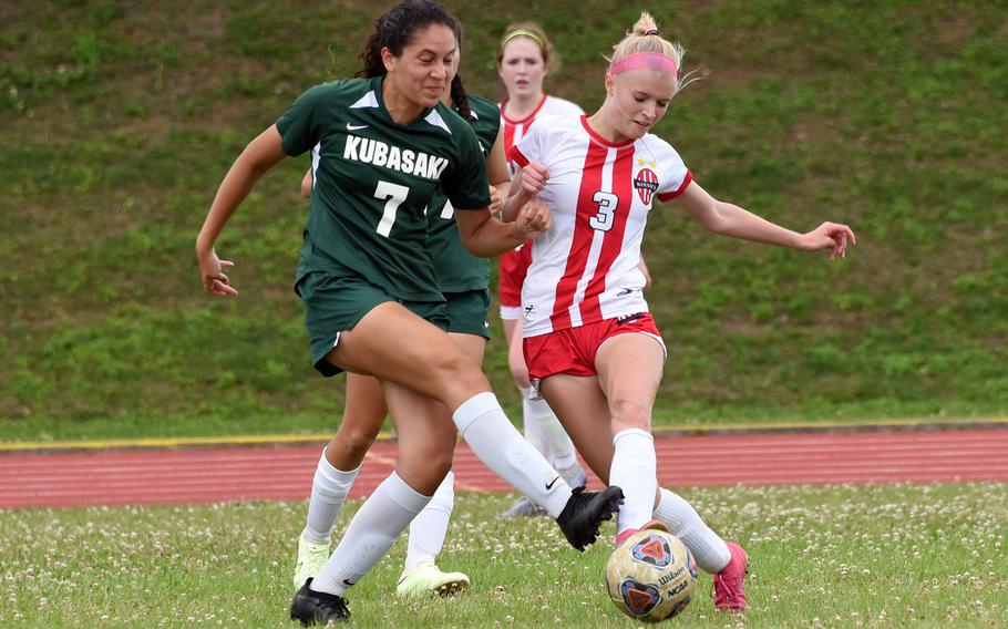 Kubasaki's  Sophia Grubbs and Nile C. Kinnick's Hailey Witt scuffle for the ball during the Dragons' 2-0 win over the Red Devils in Tuesday's Division I girls soccer semifinal.