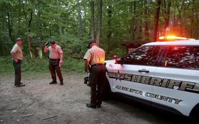 Authorities secure the entrance to Mine Bank Trail, an access point to the rescue operation along the Blue Ridge Parkway where a Cessna Citation crashed over mountainous terrain near Montebello, Va., Sunday, June 4, 2023. (Randall K. Wolf via AP)