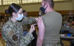 U.S. Air Force Maj. Sarah Ringdahl, 60th Dental Squadron periodontist, administers a COVID-19 vaccine to Capt. Marshall Neubauer, USAF Reserve Officers' Training Corps Assistant Professor of Aerospace Studies, Jan. 8, 2021 at Travis Air Force Base, California. The Air Force has set a Nov. 2 deadline for active-duty airmen and guardians to be fully vaccinated against the coronavirus, and Dec. 2 for reservists and Guardsmen, unless they have a valid exemption. 