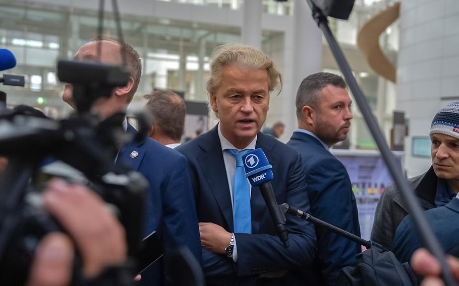 Bodyguards flank Geert Wilders, leader of the Party for Freedom, as he speaks to the media after casting his vote in the Dutch general election on Nov. 22, 2023, in The Hague, Netherlands. 
