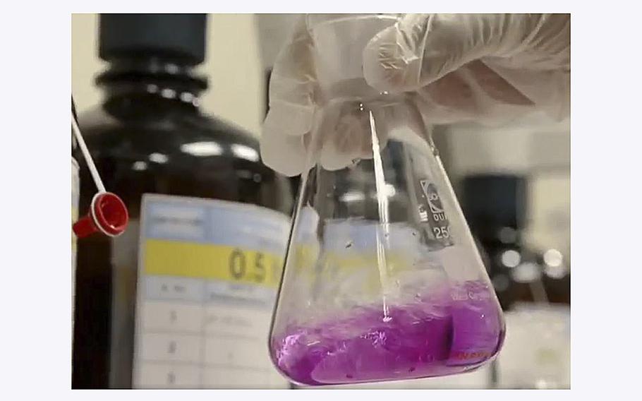 A screen grab shows laboratory work being performed in a video posted on the Abu Dhabi National Oil Company’s Facebook page promoting the production of blue ammonia.