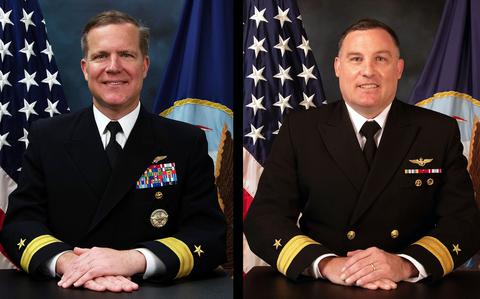 Side-by-side portraits of two U.S. Navy officers in dress uniforms posing with their hands folded on the table in front of them and U.S. and Navy flags behind them.