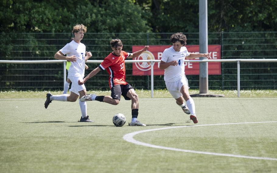 Orlando Niolu, a senior with the American Overseas School of Rome Falcons, is contested by the Rota Admirals during the Division II DODEA European Championships at Reichenbach-Steegen, Germany on May 20, 2025.
