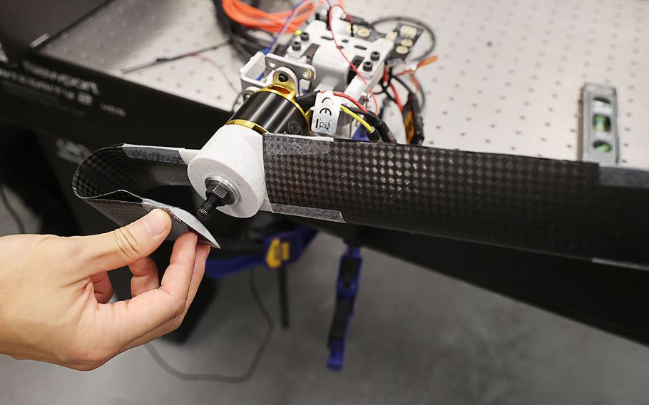 University of Central Florida Assistant professor Kawai Kwok demonstrates a bendable propeller, at the Structures & Materials Design Laboratory, on Wednesday, June 22, 2022. Kwok’s work focuses on developing shape-changing structures. These kinds of structures can be used on space missions, for drone work and for solar sails and blades among other applications. 