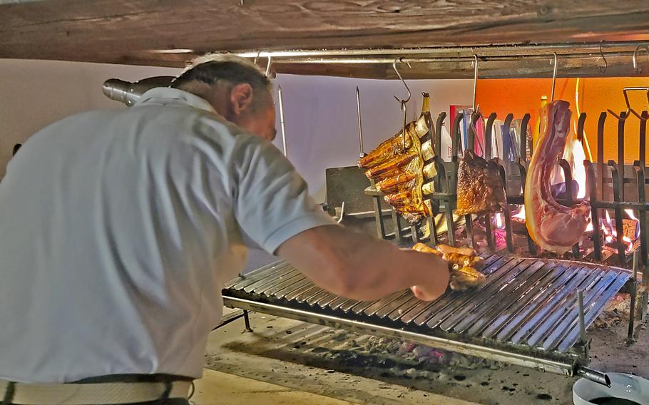 Jose Polesello, owner of Osteria El Gaucho, in Mansue, Italy, which is about a 30-minute drive from Aviano Air Base, rotates his slowly grilled meats.