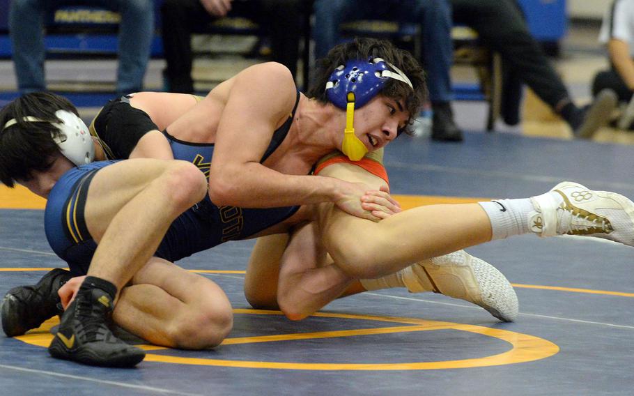 Yokota 139-pounder Kai Patton tries to control St. Mary's Jo Kajima during Wednesday's Kanto Plain dual meet. Patton won by pin in 3 minutes, 24 seconds, but the Titans won the meet 40-18.