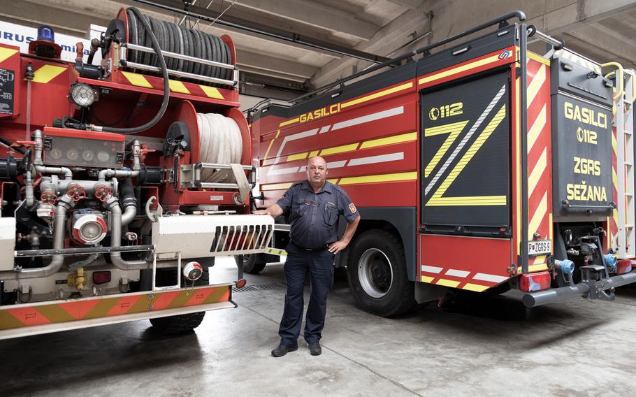 Boris Budal, Deputy Commander of the Sežana firefighters, standing near the trucks that were used in fighting the wildfires. 