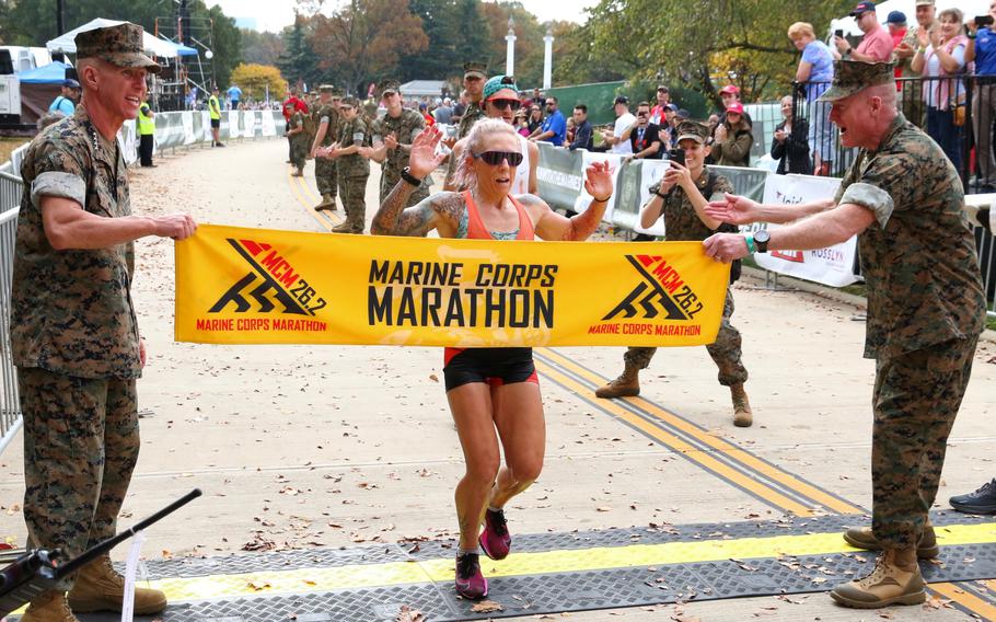 Bonnie Keating crosses the finish line as the winner of the women’s competition in the Marine Corps Marathon on Oct. 29, 2023, in Arlington, Va. Keating finished in 2:50:49.
