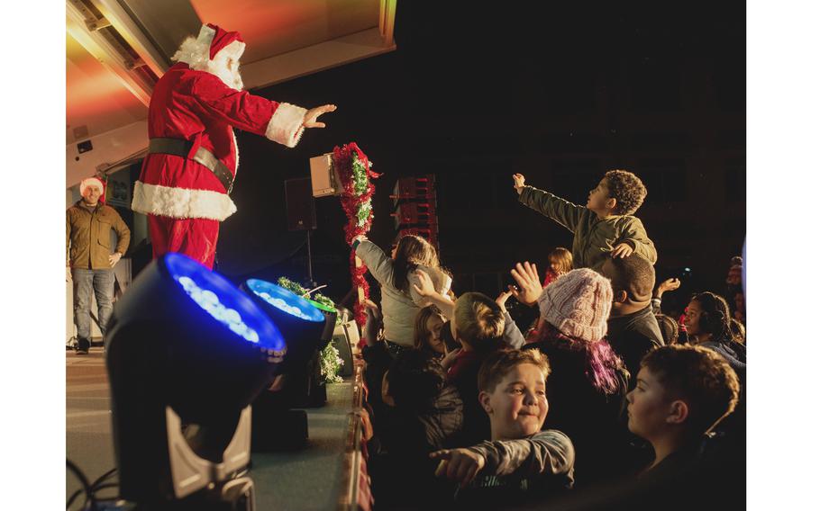 Children wave to Santa Claus onstage during the tree lighting at Marine Corps Air Station Iwakuni, Japan, on Dec. 3, 2022.