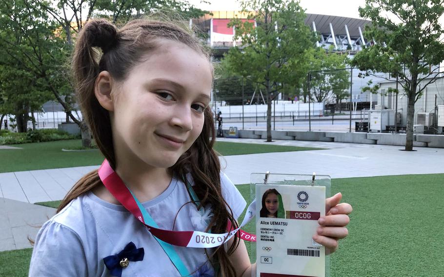 Alice Stratton, daughter of Master Sgt. Joseph Stratton, inspector general superintendent for the 374th Airlift Wing at Yokota Air Base, poses outside the Olympic stadium ahead of the opening ceremony on July 23, 2021. 