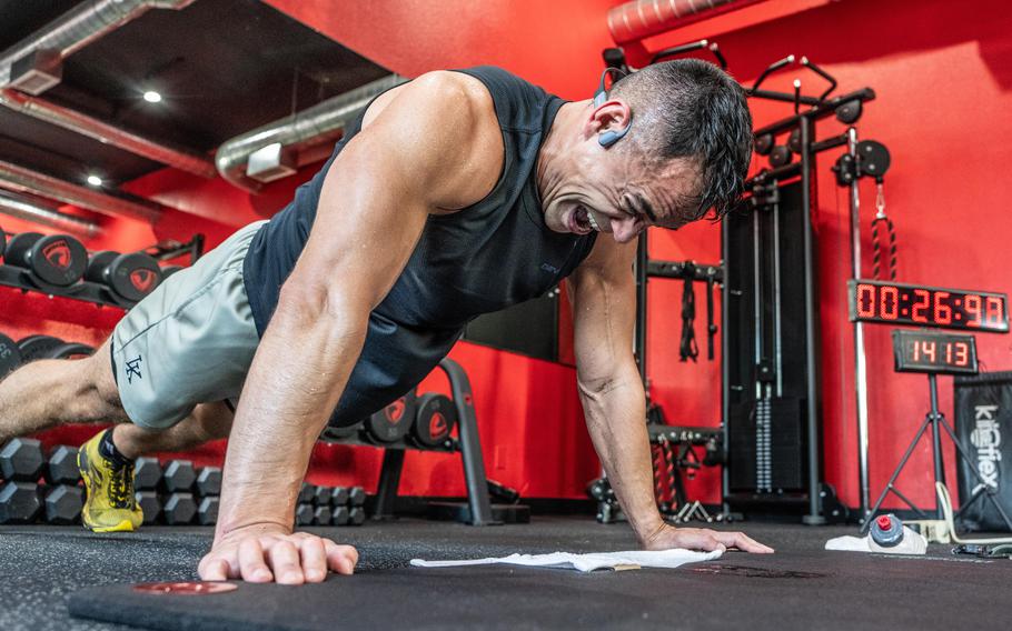 Maj. Tommy Vu grimaces with maximum effort at the apex of a pushup