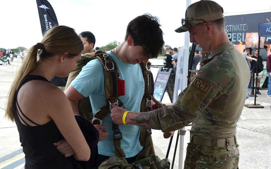 Senior Airman Chris Bowser helps Thomas Gottwald, 19, try on equipment used by Air Force Special Warfare troops at the Great Texas Air Show at Joint Base San Antonio-Randolph Air Force Base in Texas on April 6, 2024. Gottwald said he plans to join the Air National Guard after college. 