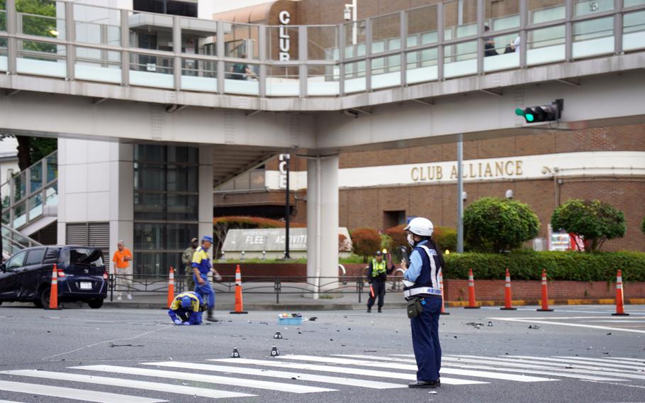 Japanese police investigate a deadly collision just outside the main gate for Yokosuka Naval Base, Japan, Wednesday, Sept. 6, 2023.
