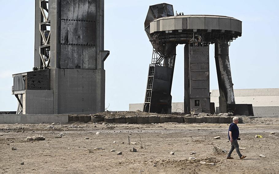 A member of the public walks through a debris field at the launch pad on April 22, 2023, after the SpaceX Starship lifted off on April 20 for a flight test from Starbase in Boca Chica, Texas.