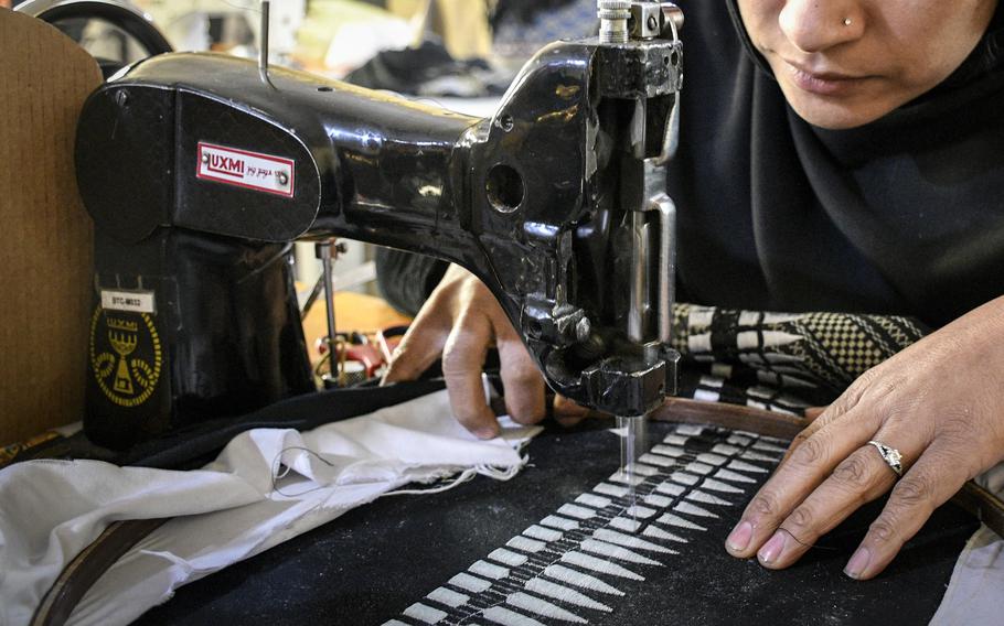 A Combat Flip Flops worker in Kabul sews an Afghan scarf, known as a shemagh. The factory made scarves and flip-flops for a business that was started by a U.S. veteran.