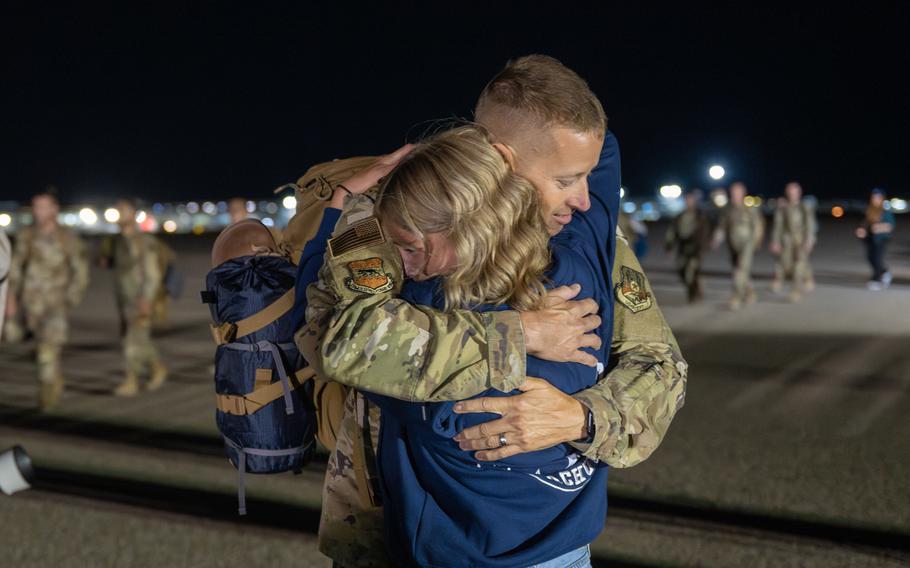 An airman hugs a girl