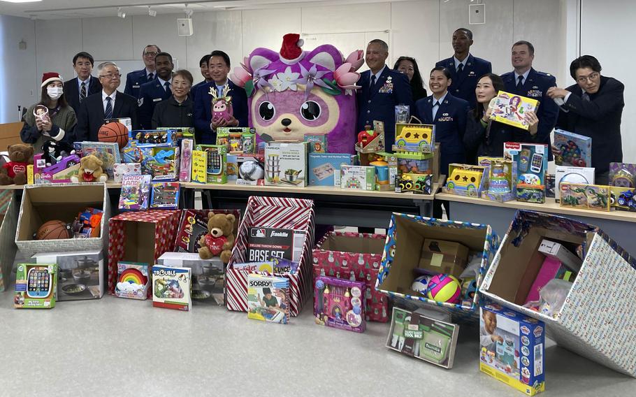 Airmen from the 374th Maintenance Group and Japanese citizens of Mizuho city pose inside city hall in western Tokyo, Japan, Dec. 14. 