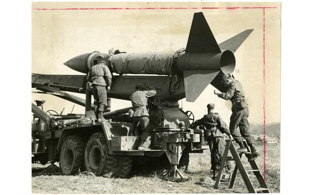Camp St. Barbara, South Korea, Feb. 27, 1959: Men from D Battery, 1st Field Artillery Battalion, 31st Artillery Regiment of the 7th U.S. Infantry Division, at Camp St. Barbara, Korea prepare an Honest John rocket for its first airburst firing. The battalion is the only 7th Infantry Division unit employing the surface-to-surface weapon. "We practice every day," Capt. Richard Trefry, the battery commander, said, "but fire only 12 times a year." "In training there is always the anti-climax when they push the plunger and nothing happens." Pvt. Jerry White, one of the newest members of the battery, pushed the button that launched "Old Diablo" on its way. He described it as a "good feeling." "You almost feel like the missile was your own," he said.

Pictured here is a scan of the original 1953 print created by Stars and Stripes Pacific's photo department to run in the print newspaper. The red marks indicate the crop lines. Only the part of the image inside of the marks would appear in the newspaper. As all pre-1964 Stars and Stripes Pacific negatives and slides were unwittingly destroyed by poor temporary storage in 1963, the prints developed from the late 1940s through 1963 are the only images left of Stripes' news photography from those decades. Stars and Stripes' archives team is scanning these prints to ensure their preservation. 

Looking for Stars and Stripes’ historic coverage? Subscribe to Stars and Stripes’ historic newspaper archive! We have digitized our 1948-1999 European and Pacific editions, as well as several of our WWII editions and made them available online through https://starsandstripes.newspaperarchive.com/

META TAGS: Pacific; South Korea; U.S. Army; infantrymen; Infantry; rocket; missile; launch; training; exercise; nuclear missile