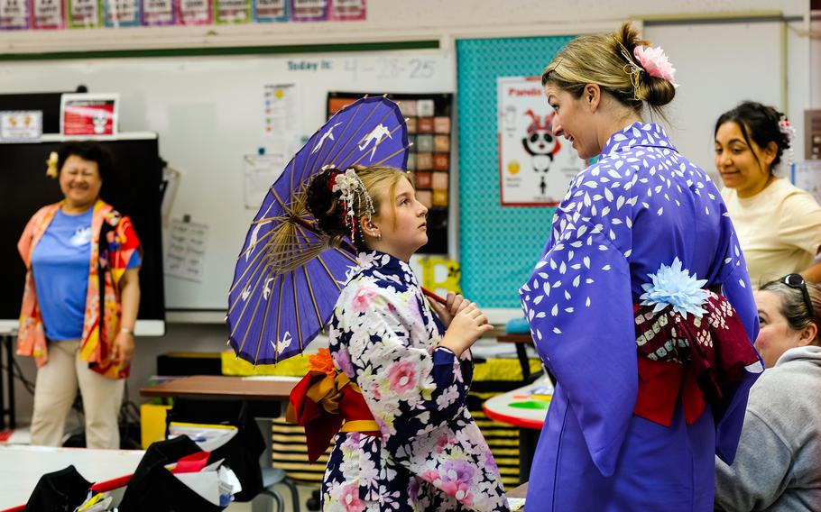 Third-grade teacher Danielle Bowles and her daughter, Brooklyn Bowles, try on kimonos.