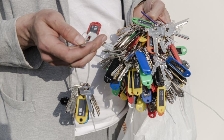 A worker at the construction site for temporary holds keys for the new units. 