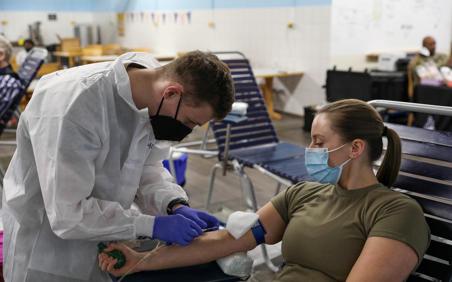 Capt. Shelby Aleksick, a nurse with 30th Medical Brigade, donates blood at Rhine Ordnance Barracks, Kaiserslautern, Germany, Jan. 12, 2022.