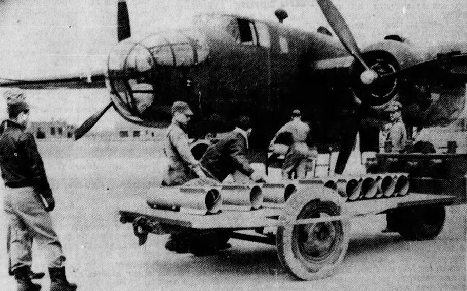 A crew loads a bomber plane with parachute flares to test them on the Jefferson Proving Ground in March 1943.