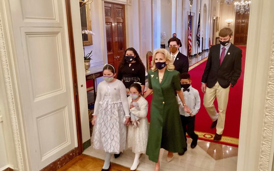 First Lady Jill Biden enters the White House’s East room with child caregivers of wounded veteran parents on Wednesday, Nov. 10, 2021. 